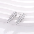 Close-up of geometric silver earrings featuring marquise-cut cubic zirconia stones - Marquise