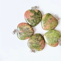 Five heart-shaped Unakite natural stone pendants with silver metal clasps on white background - Unakite