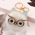 White fluffy owl keychain with gold sequin accents and metal glasses on magazine background - 8cm / Off White