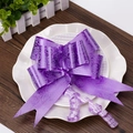 Close-up of a large purple ribbon bow with glossy rose patterns for wedding gift decor - Rose Print Purple