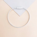 Silver metal wire keychain ring with screw lock on a minimalist geometric background - White