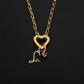 Stainless steel heart clasp necklace with initial L and pink gem pendant in gold - S