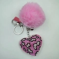 Close-up of a pink rhinestone leopard heart keychain with a soft plush faux fur ball - Pink