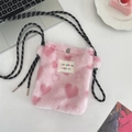 Detailed view of pink plush heart bag featuring woven strap and metal snap closure - Small Heart Light Pink