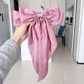 Elegant pink satin bow hair clip with a silky texture and a stylish spring fastener - Lotus Pink