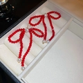 Elegant red beaded and pearl bow knot earrings displayed in a beige jewelry box - 39# Silver Pin - Red (Crystal Bowknot)
