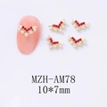 Detailed view of V-shaped gold nail charms with red rhinestones and white pearls, size 10x7mm - Gold Base Red Rhinestone Style (AM78)