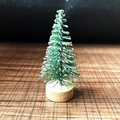 Miniature green Christmas cedar tree with white snow dusting and a round wooden base - 4-5cm (No Bark Base)