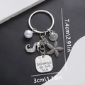 Detail of silver ocean keychain with seahorse, shell charms and Dreaming of the Sea tag - Ocean Seahorse Keychain-ER696