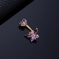 Macro shot of gold belly ring featuring purple zircon butterflies on a black surface - Purple Zircon Butterfly Gold