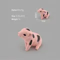 Miniature pink pig figurine with black spots and realistic skin texture for desk decor - Sitting Piglet ZQ385
