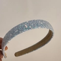Close-up of a blue sequined headband with fine glitter texture and beige fabric lining - Light Blue