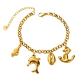 Macro shot of gold stainless steel ocean charms including shell, dolphin, and anchor - Dolphin