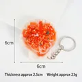 Realistic PVC garlic scallop keychain showing dimensions of 6cm x 6cm and 23g weight - Red Oil Vermicelli Scallop-Keychain