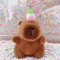 Brown capybara plush keychain with pink peach accessory and soft fluffy texture - Dark Brown Peach + Bead Chain