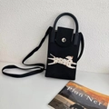 Detail view of mini black knitted phone bag featuring leopard cat pattern and metal buckle - Black Spotted Dog