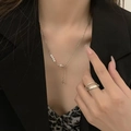 Silver star and pearl Y-shaped necklace with a double-layered open ring on a model - Hexagram Necklace