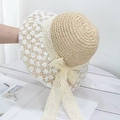 Detailed macro view of the beige straw sun hat featuring white floral lace and bow accents - Small Floral Beige