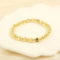 Detail of gold beaded bracelet with diamond-cut facets in a white shell display tray - BR1683-D/Gold Faceted Round Beads