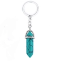 Detailed shot of hexagonal turquoise stone pendant on a silver metal keychain - Turquoise