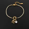 Elegant 14K gold plated stainless steel bracelet featuring letter M and crystal charms - M