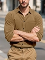 Detailed close-up of corduroy texture and dual breast pockets on a men's khaki casual shirt - Camel