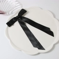 Elegant black satin double-layered bow hair clip with long streamers on a white plate - Black