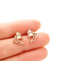 Detailed close-up of gold metal stud earrings featuring a minimalist long-haired girl profile - Rose Gold