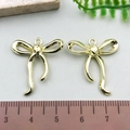 Golden bow-knot alloy pendants for DIY jewelry making shown with 3cm ruler scale - Curved Bowknot - KC Gold (21402)