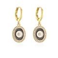 Detailansicht goldener Evil Eye Ohrringe mit Zirkonsteinen und Emaille-Akzenten - Schwarz