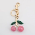 Roze glitter kersensleutelhanger met gouden metalen sluiting voor tassen - Roze grote en kleine kers met licht goud