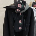 Knitted scarf featuring pink floral jacquard patterns on black with green checkered reverse - Black