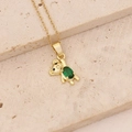 Detail of a gold bear necklace with an emerald green gemstone inlay on textured stone - Emerald Green Bear (4#)