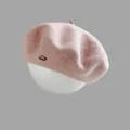 Pink wool beret for women with metal letter badge displayed on a model head - M (56-58cm) / Pink