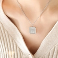 Silver square pendant necklace with radial texture and heart-shaped green stone on a model - 40+5cm / Steel Color White Zirconia Necklace