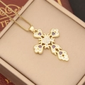 Detail of 18K gold cross pendant necklace with zircon and purple gemstones in jewelry box - Purple