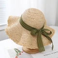 Close-up of wide brim raffia hat featuring raw edges and army green ribbon bow - Light Green Ribbon