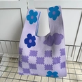 Cute knitted tote bag with purple flower patterns and checkerboard texture on metal rack - Purple Small Clouds