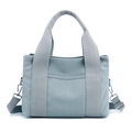 Light grey blue canvas handbag with adjustable wide strap and front pocket in variant view - Grey Blue