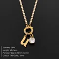 Stainless steel initial U necklace with sparkling rhinestone pendant in 14K gold finish - Letter U (XNL0103)