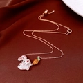 Close-up of rose gold bunny and carrot pendant necklace with crystals on silk fabric - Rose Gold Rabbit & Carrot (WN16)
