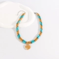 Bohemian double-layer turquoise beaded necklace with golden heart pendant on white stand - Yellow Heart Pendant Style / Yellow