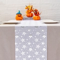 Detail view of grey table runner with white stars and snowflake prints on linen fabric - White Star