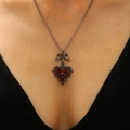 Detailed view of Gothic punk red heart necklace with bow and metallic cross pendant - Dark Red