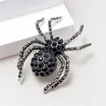 Macro shot of spider animal brooch with black crystals on a silver alloy base - Black