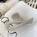 Close-up of a cream butterfly hair claw clip with cross design on a lifestyle magazine - Butterfly Buckle Ribbon (Approx 12cm) / Grey/White