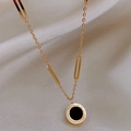 Close-up of a double-layered gold necklace with black disc pendant and Roman numerals - Gold Paperclip + Round Pendant