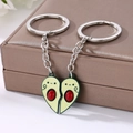 Detail of magnetic avocado couple keychains forming a heart shape on a jewelry box - Two-Piece Set / Avocado Keychain