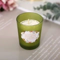 Green frosted glass jar scented soy candle with floral label and dust cover - Amber & Ginger