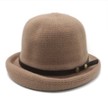 Detail of a brown knit basin hat featuring a leather strap and bronze metal buckles - M (56-58cm) / Brown